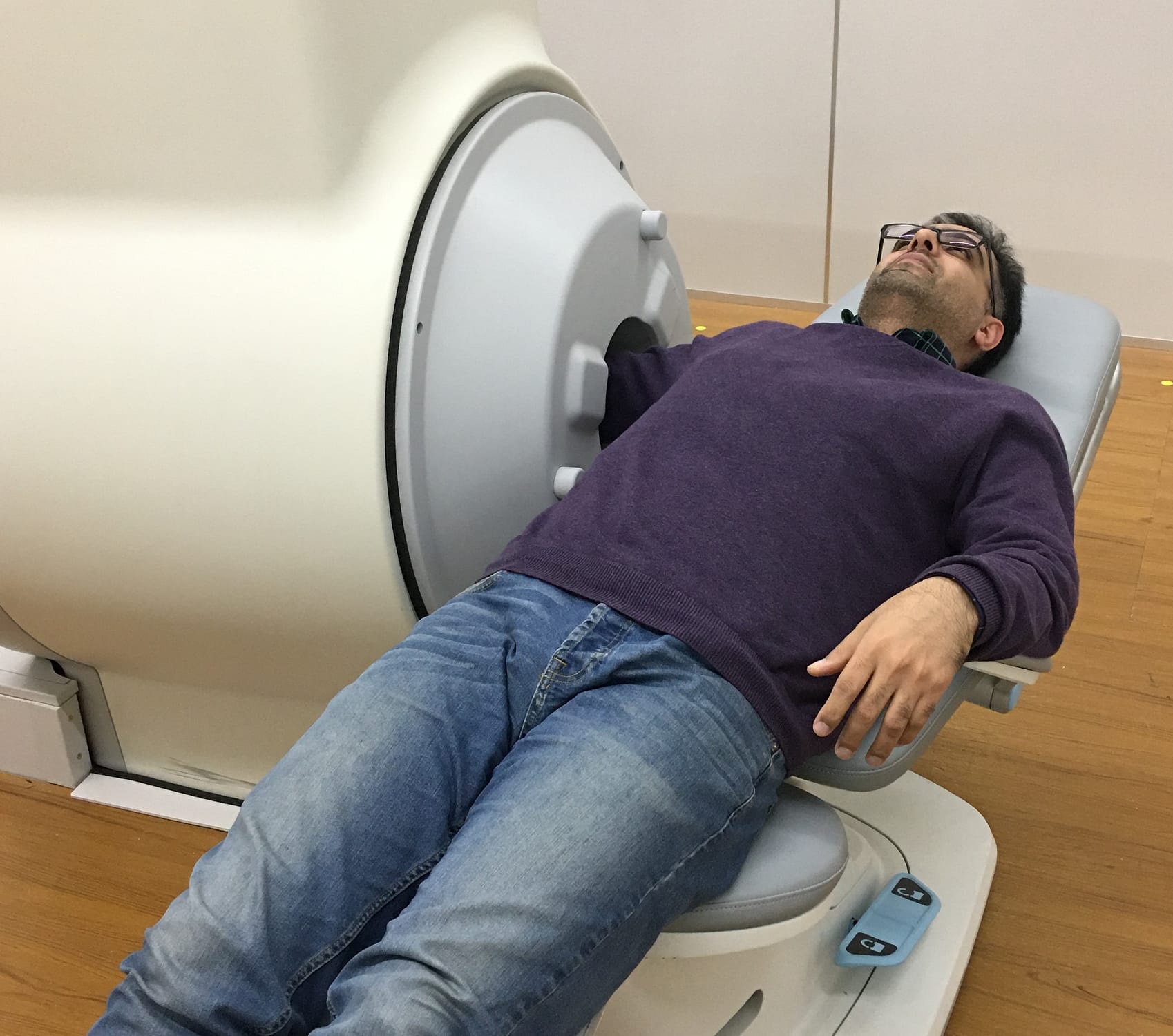 Compact MRI Systems for extremities - The patient getting an MRI scan of the arm.