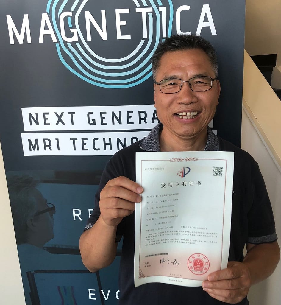 Dr Riyu Wei, one of the inventors, holding the Chinese Certificate for Magnetica's “Magnet for Head and Extremity Imaging” patent - granted in China and Japan.